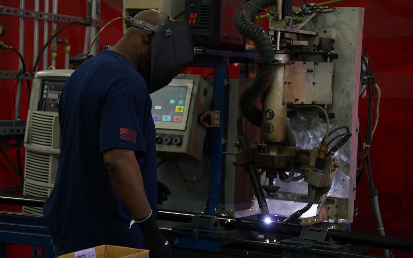 Industrial welding professional operating automated fabrication equipment
