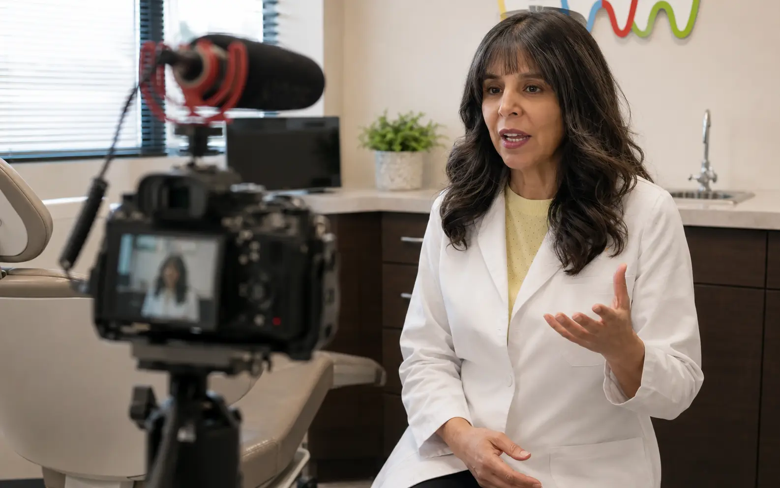 Dr. Patricia Rojas recording a video advertisement inside her orthodontic office